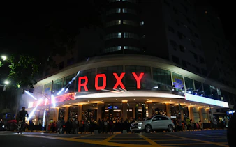 Roxy Theater exterior at night with crowd, Rio de Janeiro.