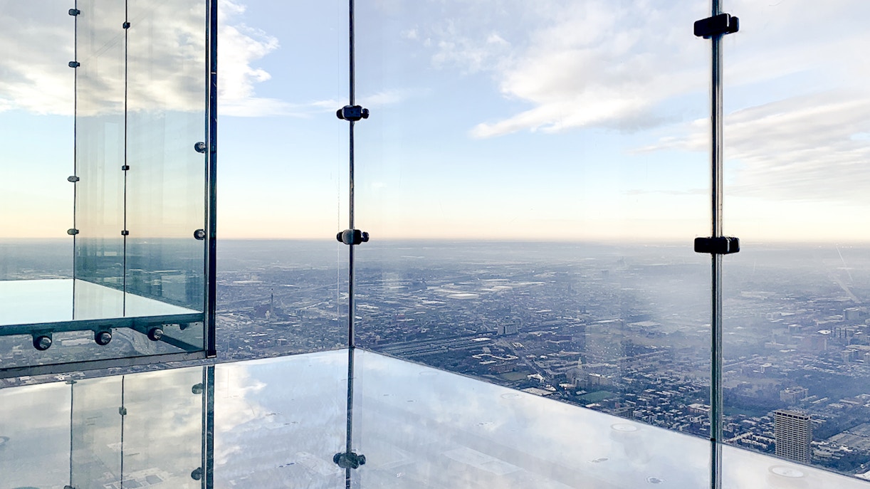 View from Skydeck at Willis Tower, Chicago, overlooking city skyline and Lake Michigan.