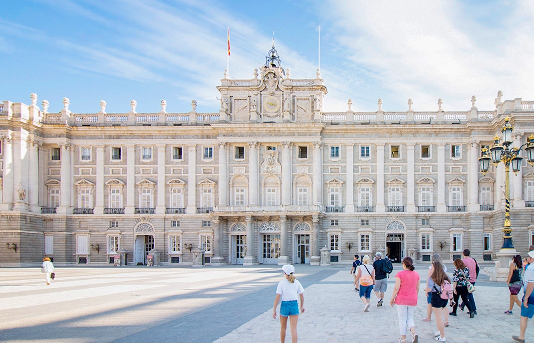 Visitors exploring the Royal Palace of Madrid's ornate interior on a guided tour with priority access.