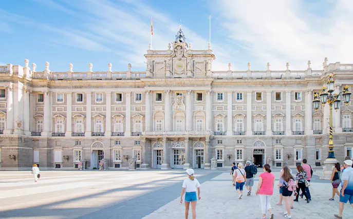 Participants entering Royal Palace of Madrid on guided tour with priority access.