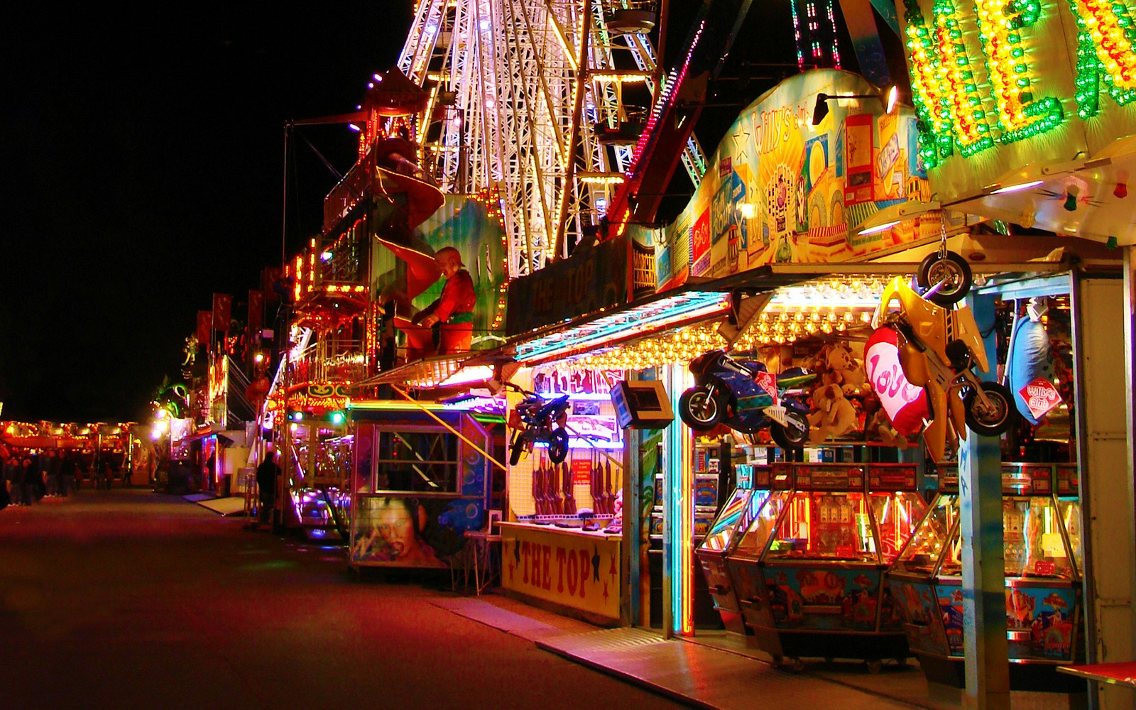 Foire du Trone amusement park rides and Ferris wheel in Paris, France.