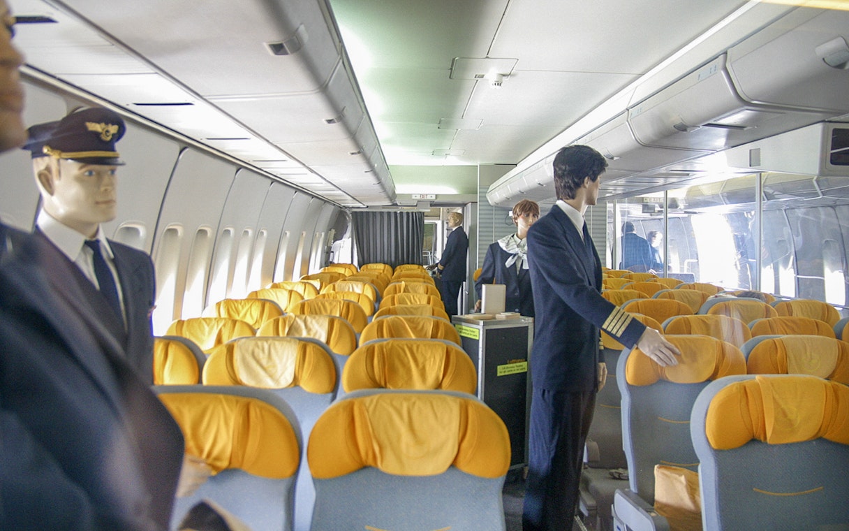 Mannequins in airplane cabin exhibit at Technik Museum Speyer.