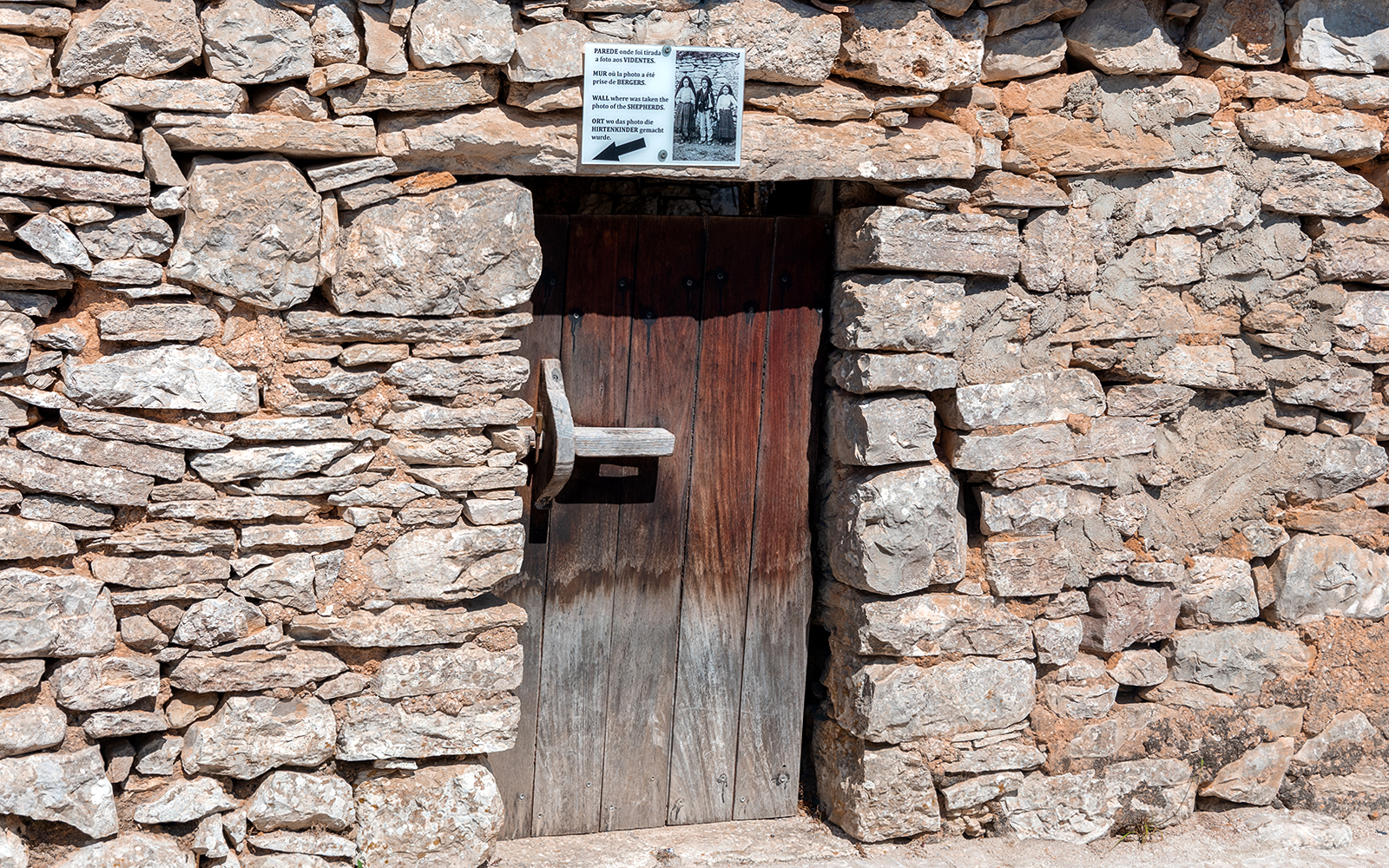Stone doorway at a historical site in Fátima, Portugal, featured on the full-day tour from Porto.