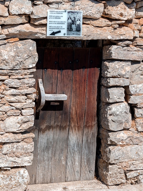 Stone doorway at a historical site in Fátima, Portugal, featured on the full-day tour from Porto.