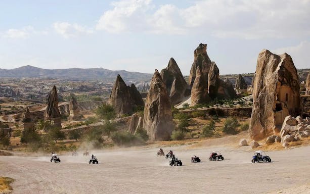 ATV riders exploring rocky landscape in Cappadocia.