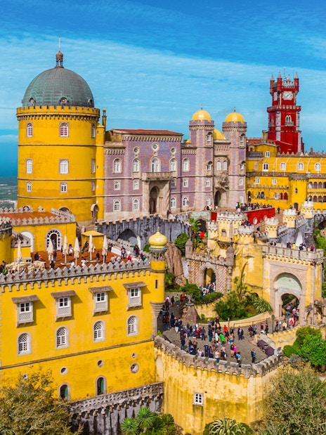Pena Palace in Sintra, Portugal, with colorful towers and lush surroundings.