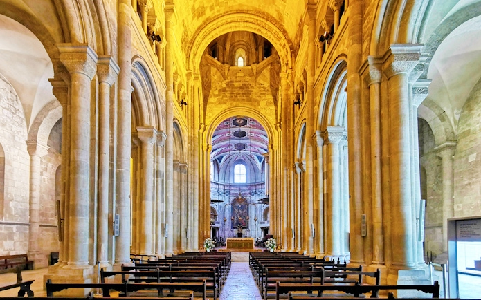 Se de Lisboa cathedral interior with stone arches and altar.