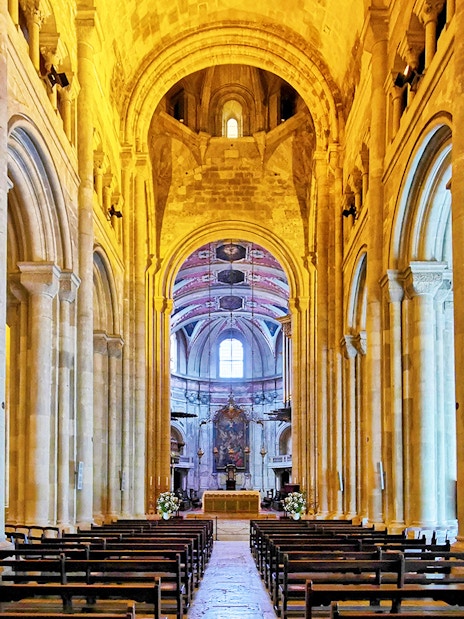 Se de Lisboa cathedral interior with stone arches and altar.