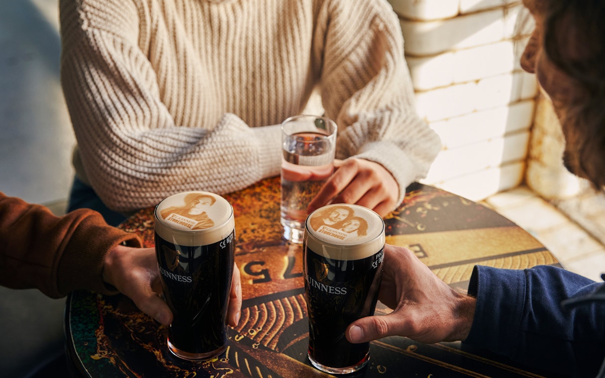 Guests enjoying personalized pints at Guinness Storehouse, Dublin.