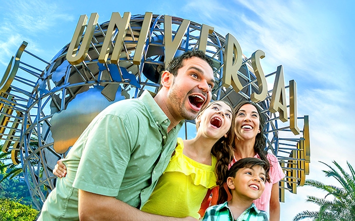 Family enjoying Universal Studios Hollywood entrance globe.