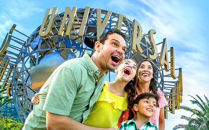 Family enjoying Universal Studios Hollywood entrance globe.