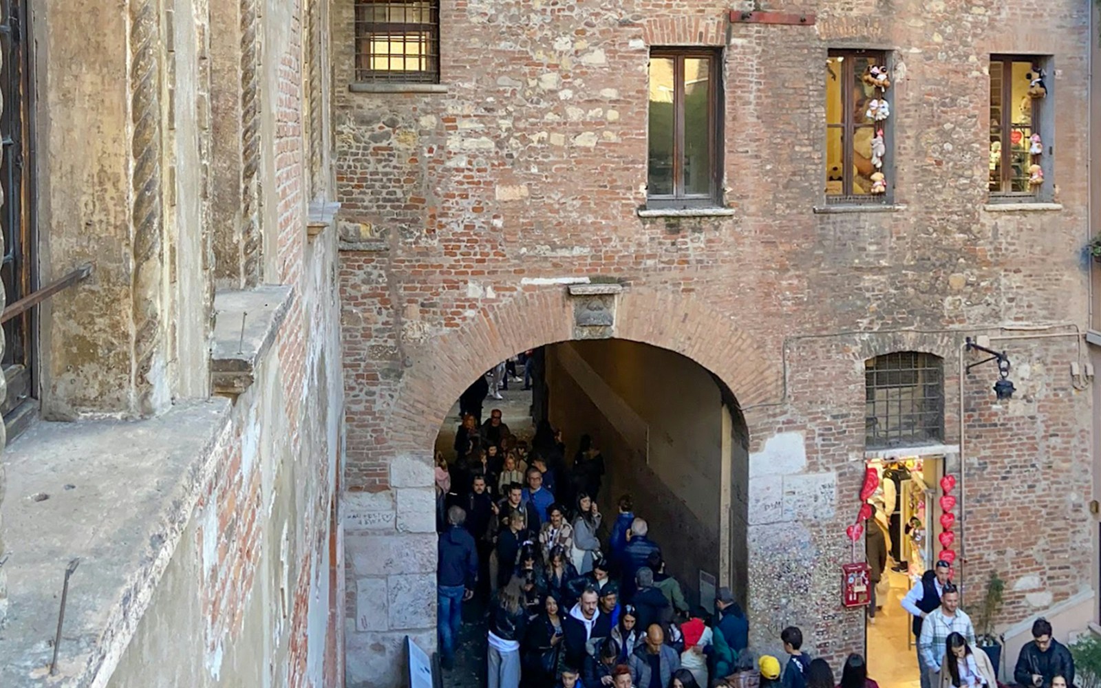 View from Juliet's House balcony in Verona showing a crowd in the courtyard below.