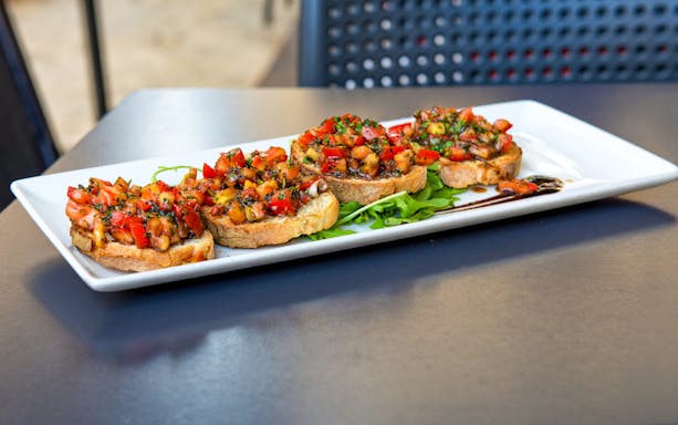 ħobż biż-żejt on a platter during a food tour in Mdina and Rabat, Malta
