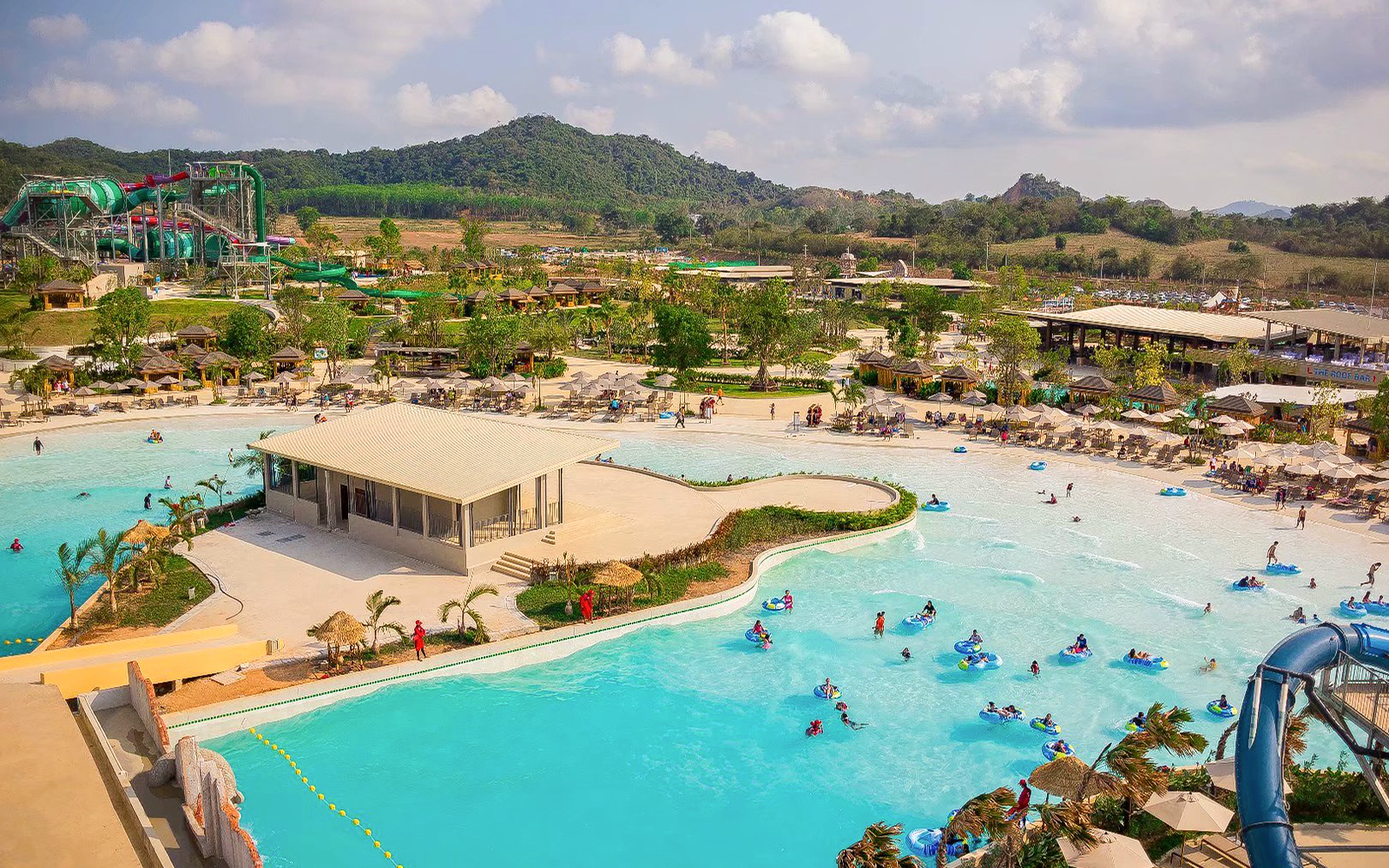Visitors enjoying wave pool and slides at Ramayana Water Park, Thailand.