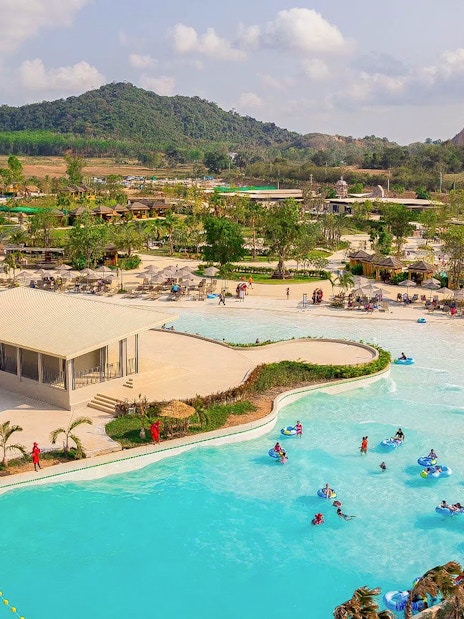 Visitors enjoying wave pool and slides at Ramayana Water Park, Thailand.