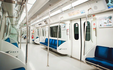 Interior of an empty AREX train in South Korea, part of the KORAIL Pass experience.