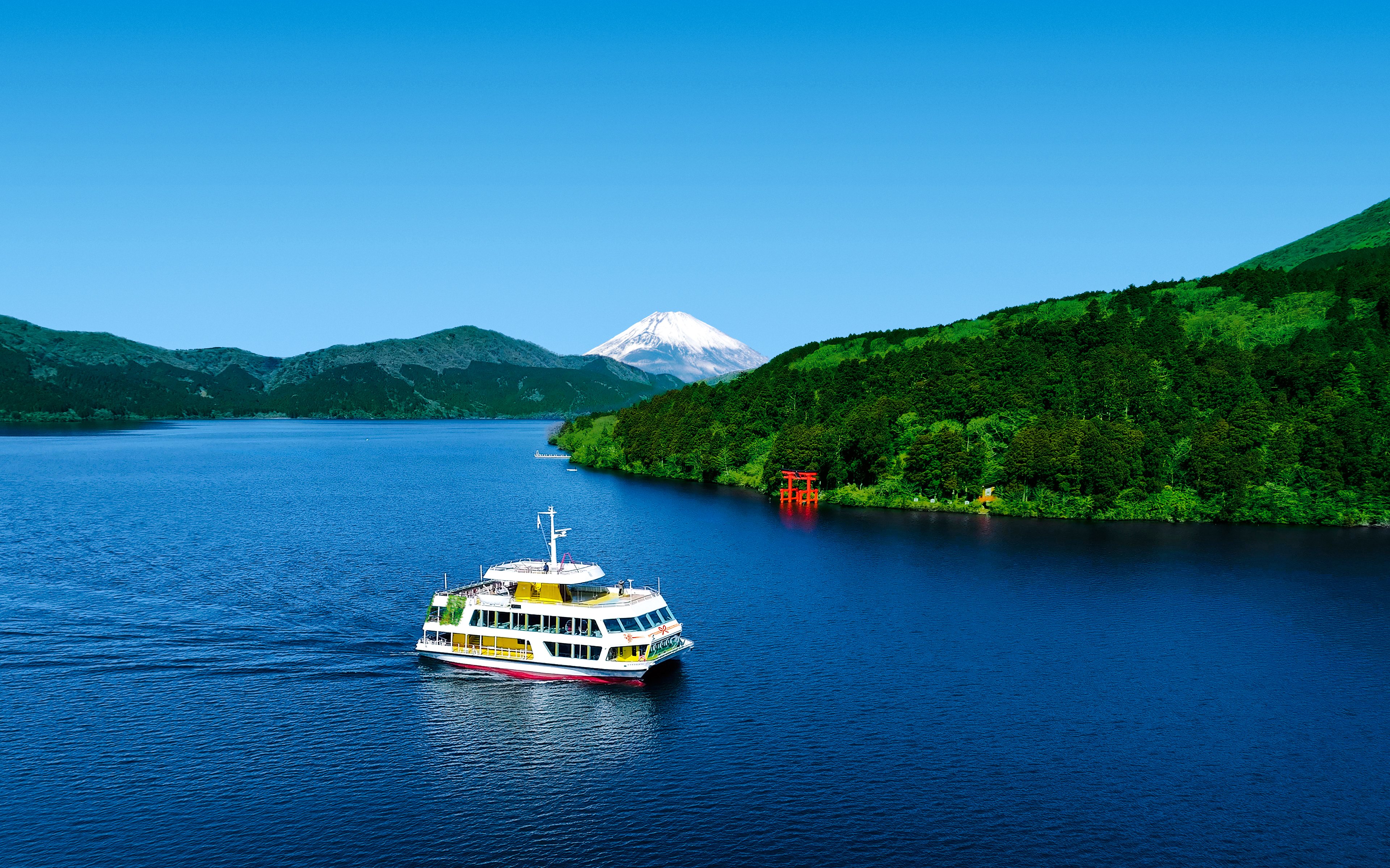 Hakone sightseeing cruise on Lake Ashi with Mount Fuji and torii gate in the background.