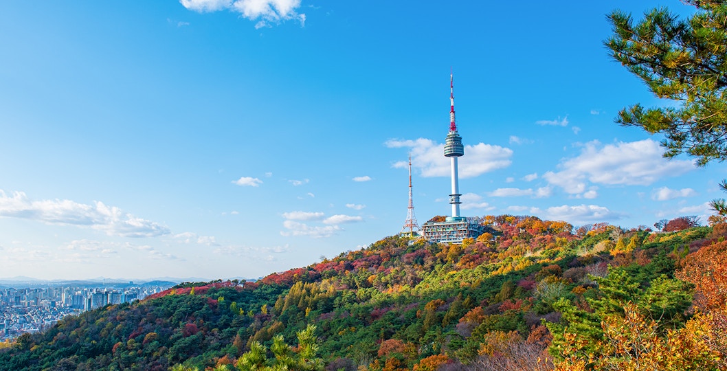 N Seoul Tower on Namsan Mountain with autumn foliage in Seoul, South Korea.