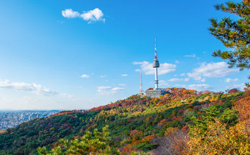 N Seoul Tower on Namsan Mountain with autumn foliage in Seoul, South Korea.