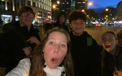 Group of people exploring Cologne at night during a self-guided city game.
