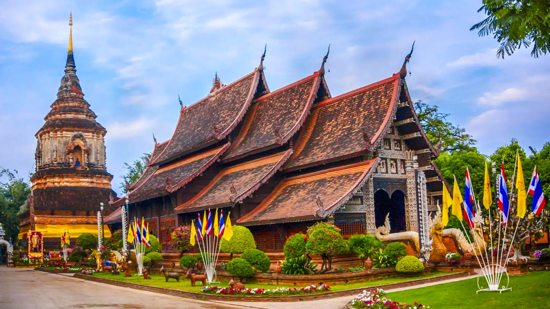 Wat Lok Moli temple with traditional architecture and flags, Chiang Mai.