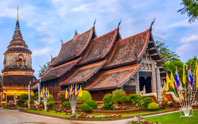 Wat Lok Moli temple with traditional architecture and flags, Chiang Mai.