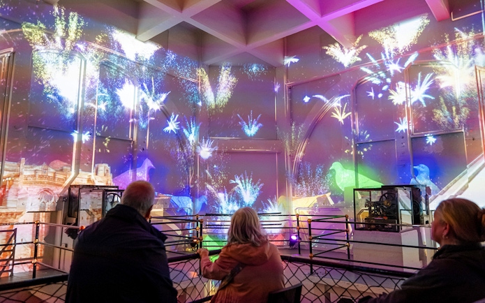 Guests watching a light show inside the Royal Liver Building, Liverpool.