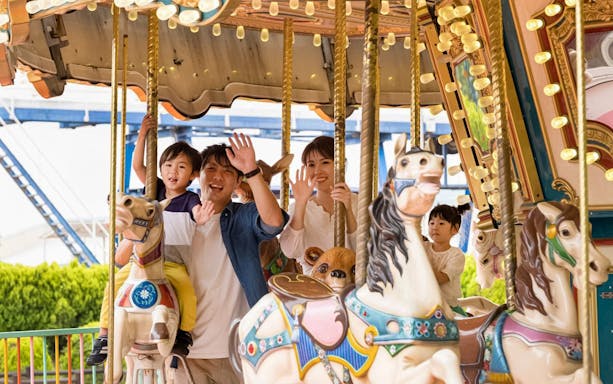 Family enjoying carousel ride at Tokyo Summerland.