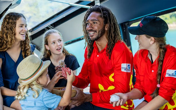 Tour guide engaging with children on the Wildcat Mackay All Inclusive Day Tour.