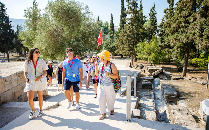 Tour group exploring Acropolis grounds on a guided tour in Athens.