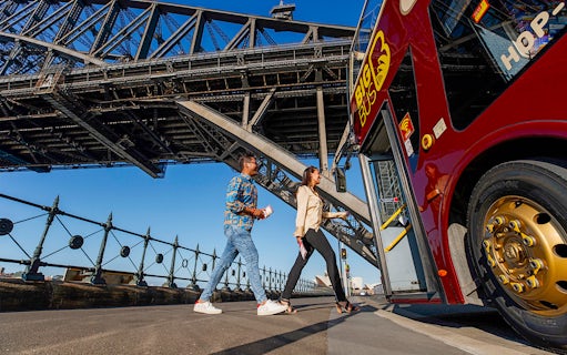 Visitors boarding Big Bus Sydney at Dawes Point with Sydney Harbour Bridge in the background.