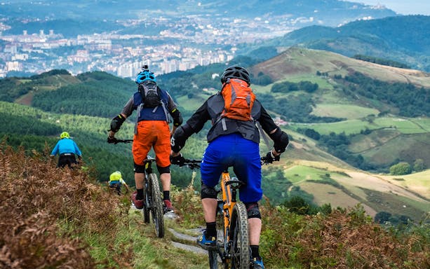 Cyclists on a guided bike tour overlooking San Sebastian's scenic hills.