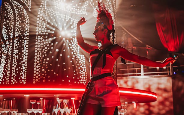 Performer on stage during Come Alive Westend show with dramatic lighting.