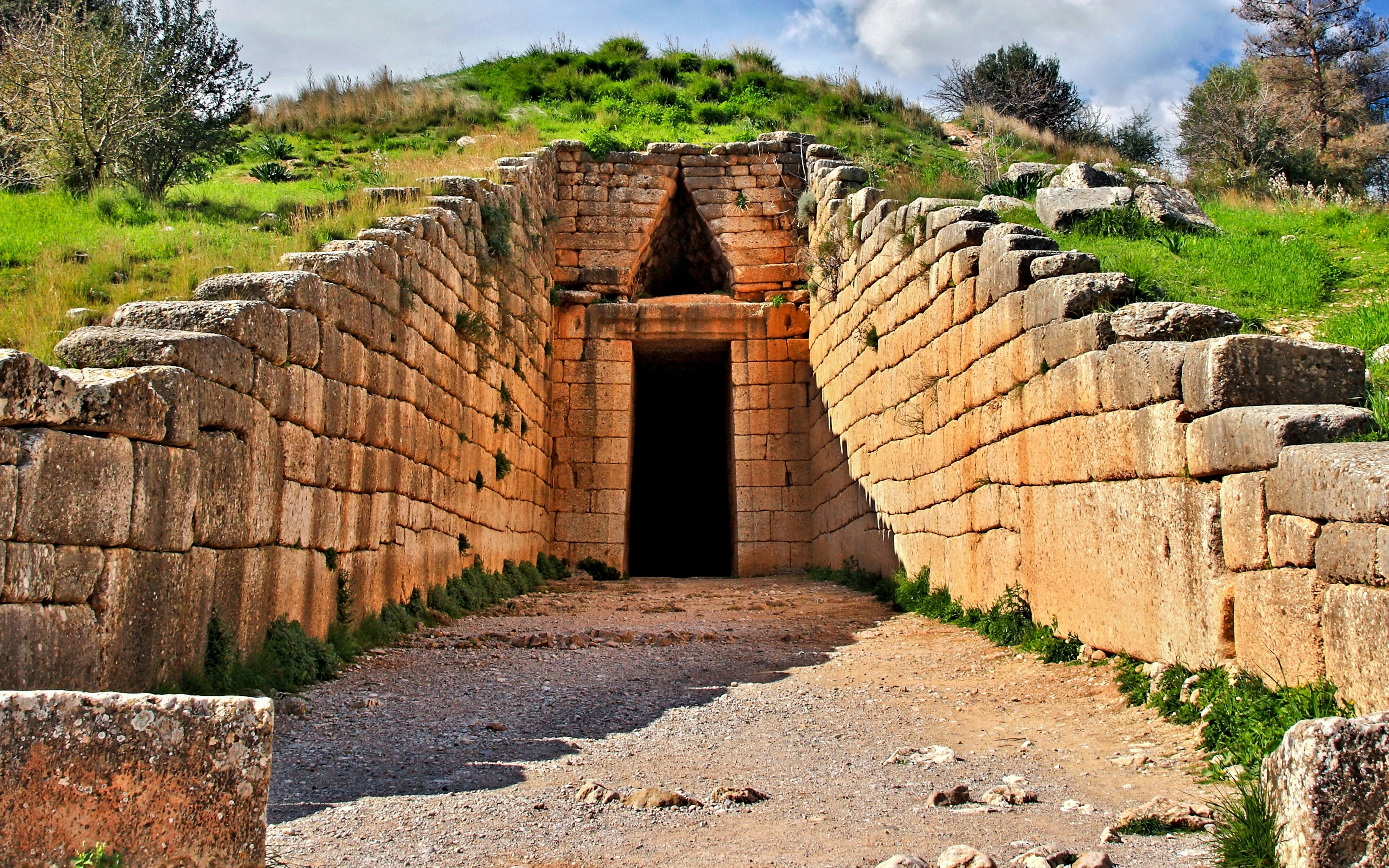 Tomb of Agamemnon entrance with stone walls, Mycenae, Greece.