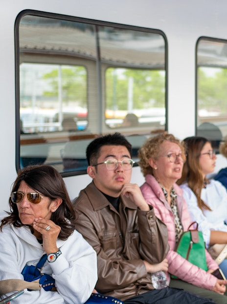Tour guide explaining safety procedures to passengers on a boat tour.