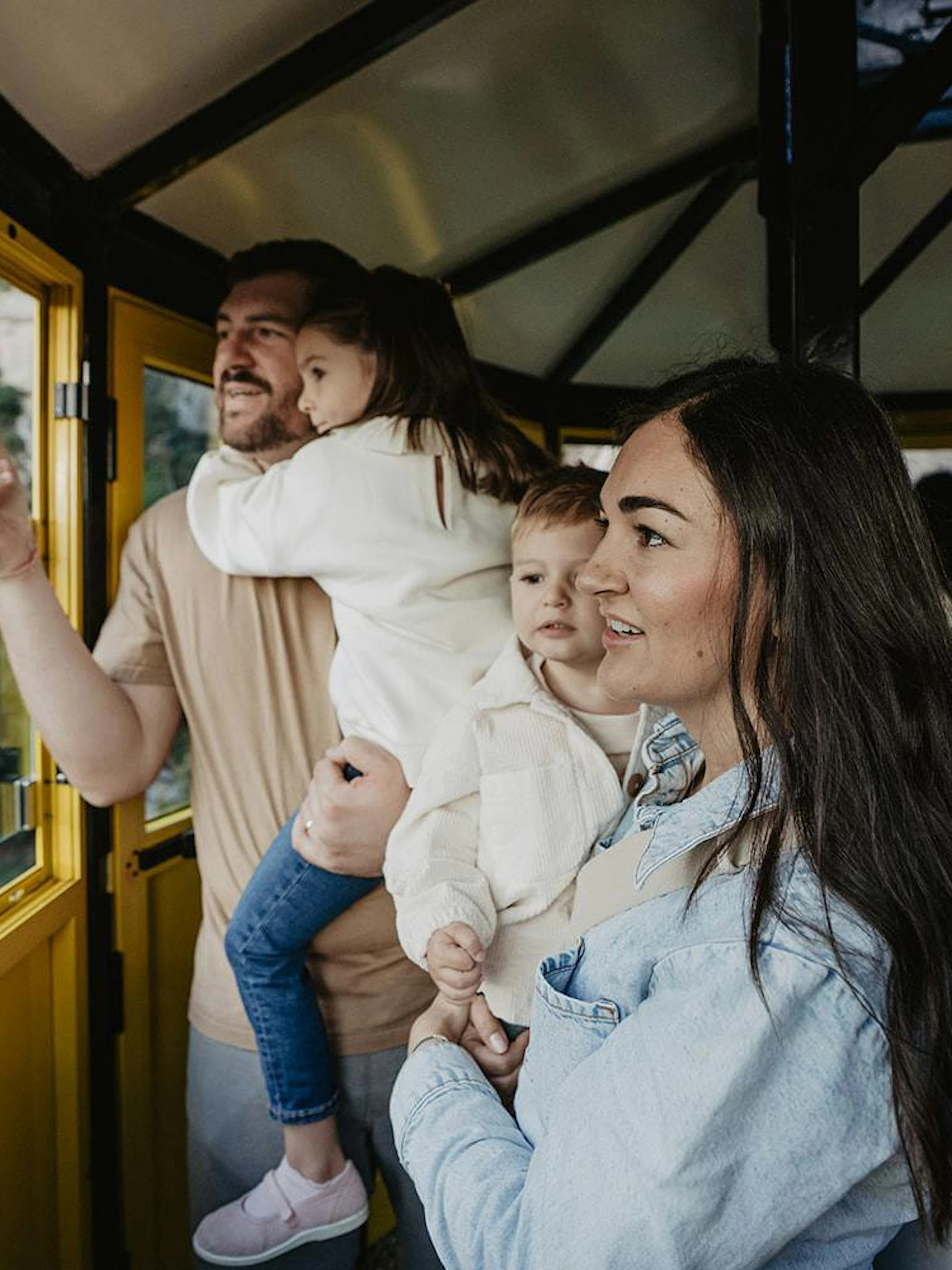 Family enjoying views from Aeri de Montserrat cable car in Spain.
