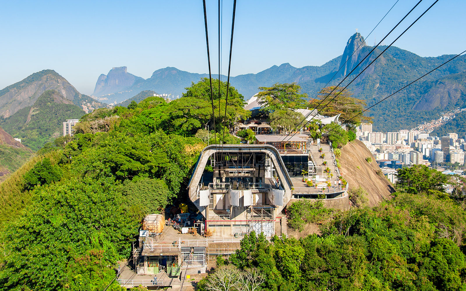 Cable car station on Urca Mountain with Rio de Janeiro cityscape in the background.