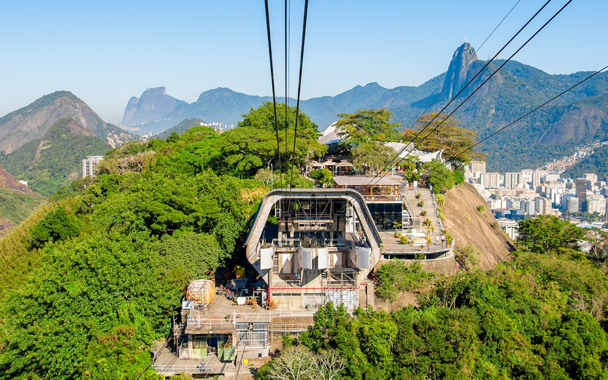 Cable car station on Urca Mountain with Rio de Janeiro cityscape in the background.