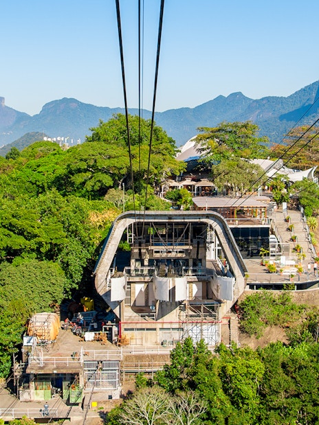 Cable car station on Urca Mountain with Rio de Janeiro cityscape in the background.