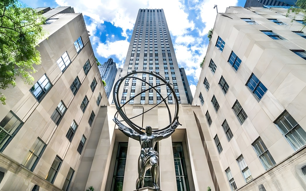 Atlas statue at Rockefeller Center, New York City, viewed from below with surrounding buildings.