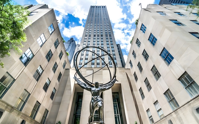 Atlas statue at Rockefeller Center, New York City, viewed from below with surrounding buildings.