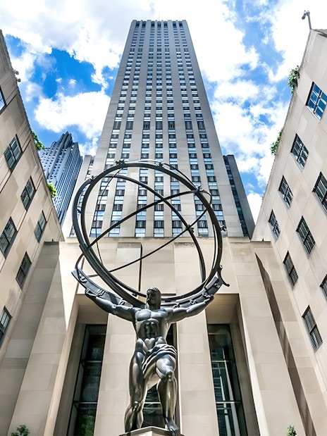 Atlas statue at Rockefeller Center, New York City, viewed from below with surrounding buildings.