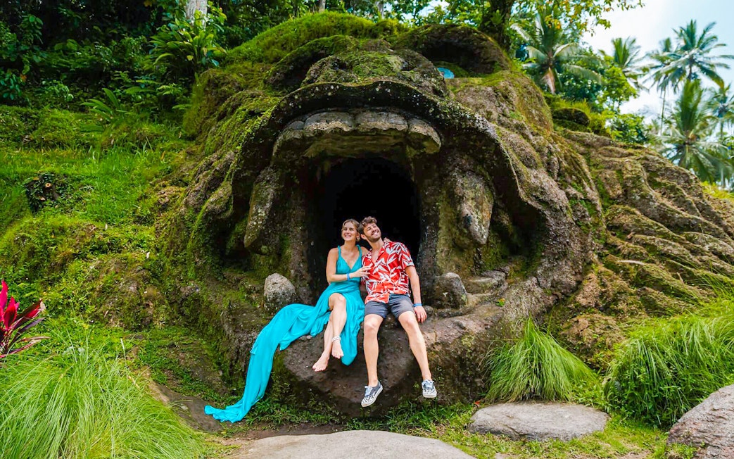Couple sitting at the entrance of Gorilla Cave, Alas Harum Bali.