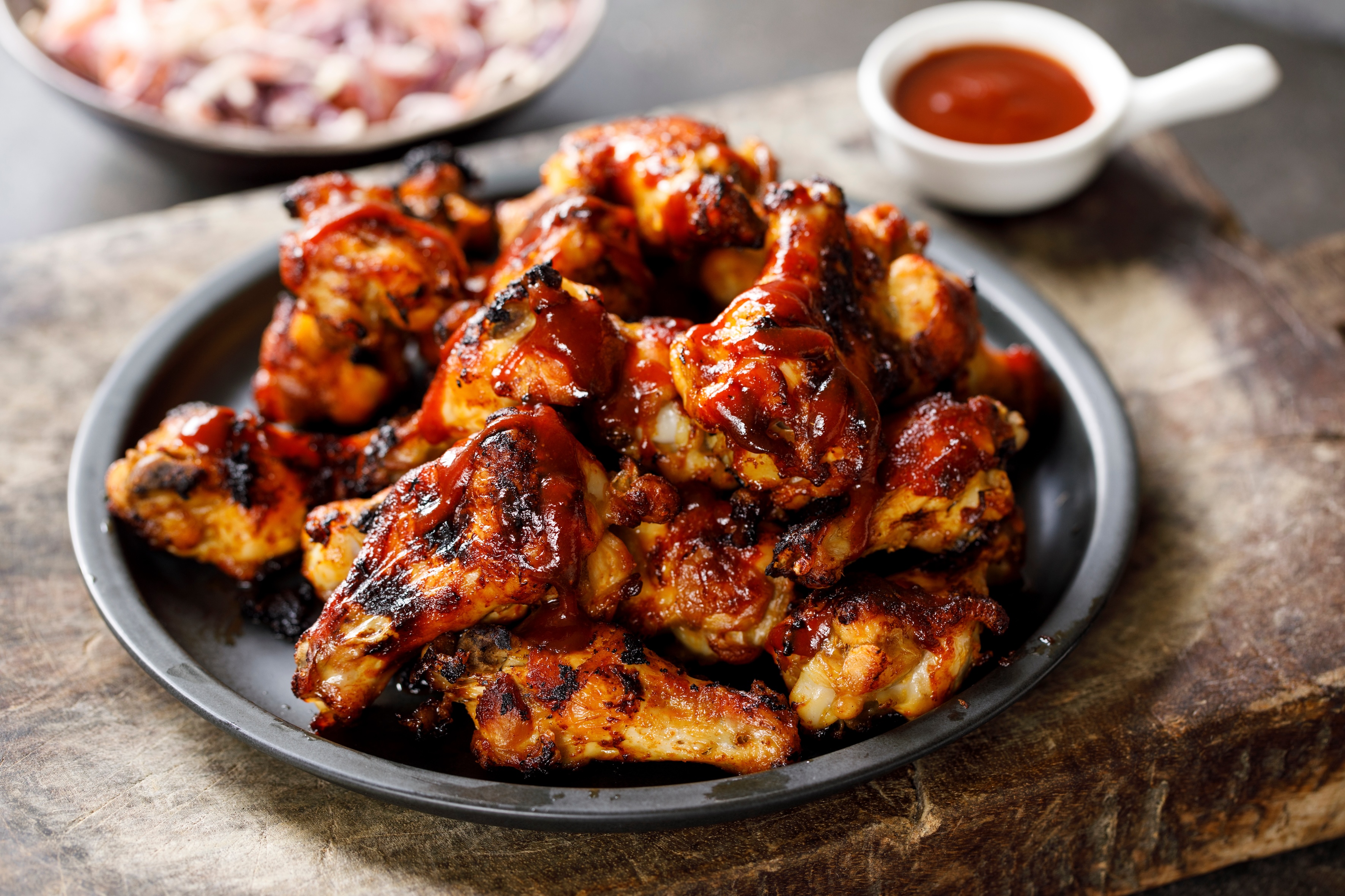 Barbecue chicken wings served on a plate.