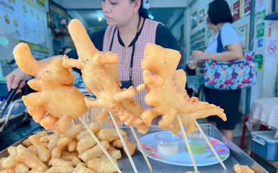 Fried dough shaped like elephants on skewers at a Chiang Mai street food stall.