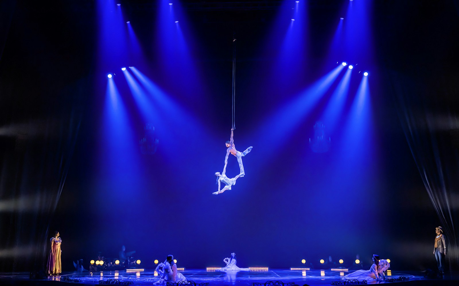 Cirque du Soleil performers in vibrant costumes on stage during Corteo show.