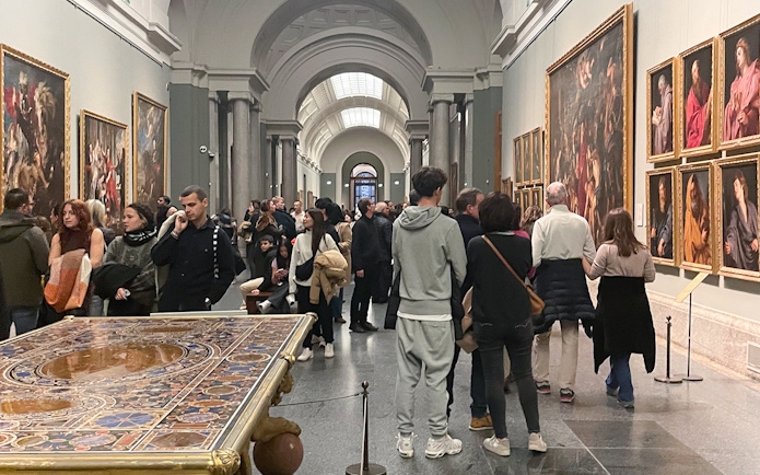 Group tour with guide at Prado Museum exhibition hall, Madrid.