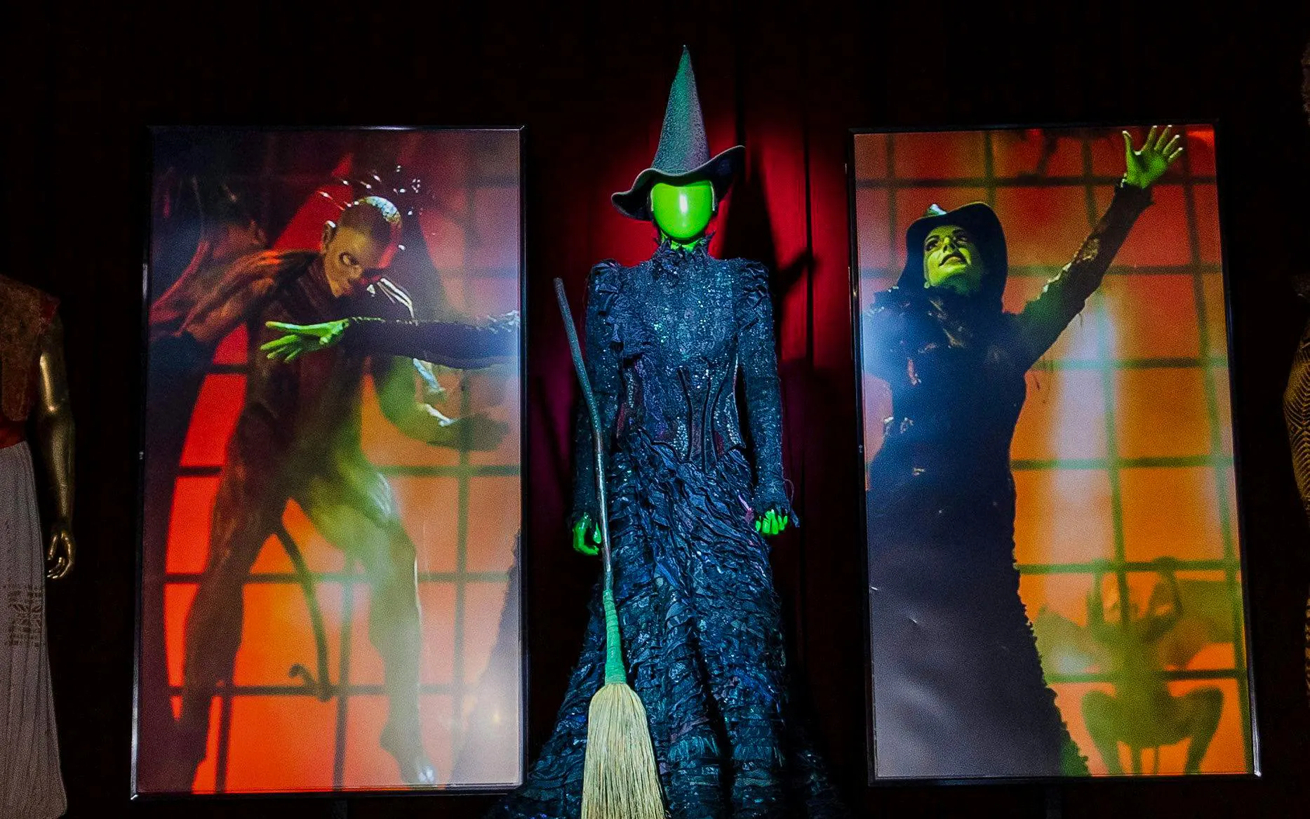 Wicked costume display with broom at RiseNY exhibit.
