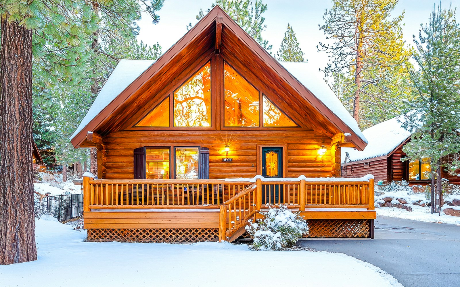 Cozy chalet in Zweisimmen nestled among snow-covered trees and mountains.