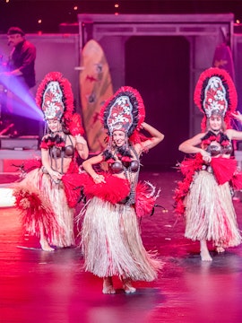 Dancers performing in traditional costumes at Rock-A-Hula Show, Honolulu.